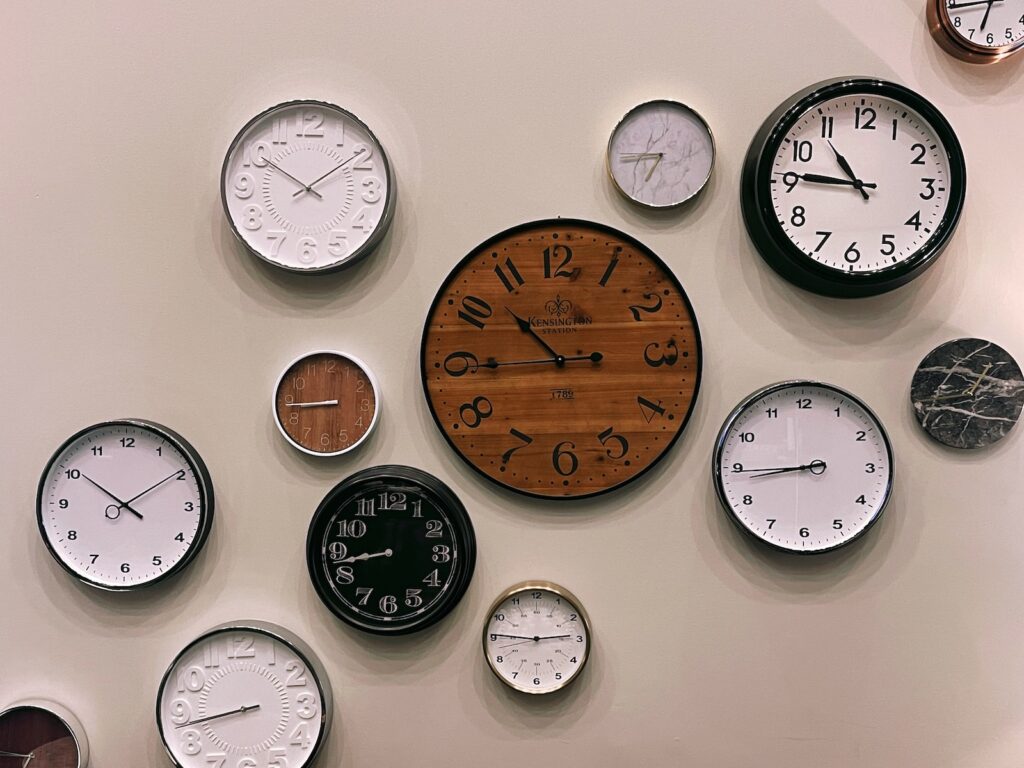 white and brown analog wall clock at 10 00